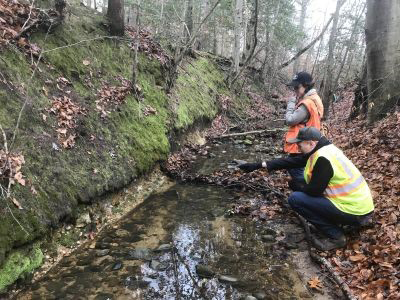 Marcie Occhi and Aaron Barth observing an exposure in a creek in the Earth MRI FY-19-20 focus area 