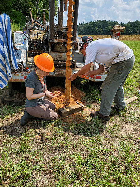 Marcie Occhi and William Lassetter examining drill cuttings from Pliocene-age sand